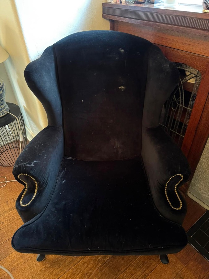 Dusty navy wingback armchair before upholstery cleaning