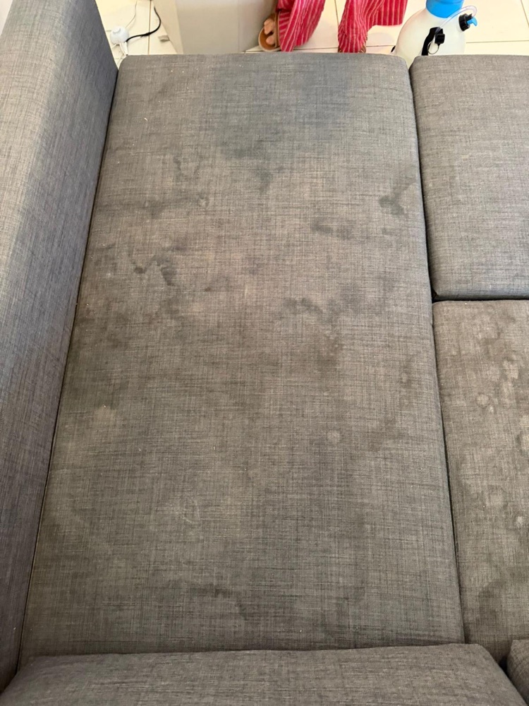 Second angle of the stained grey sofa bed before cleaning
