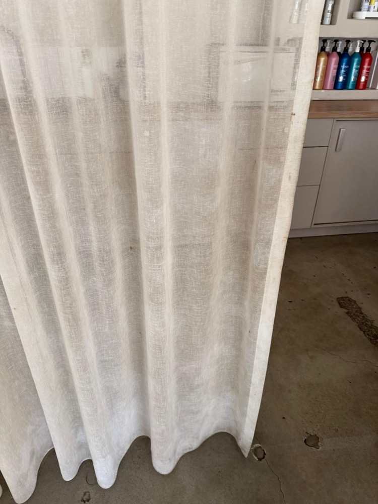 Sheer white curtain before professional cleaning