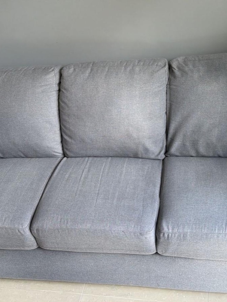 Same grey sofa clean and uniform after upholstery cleaning